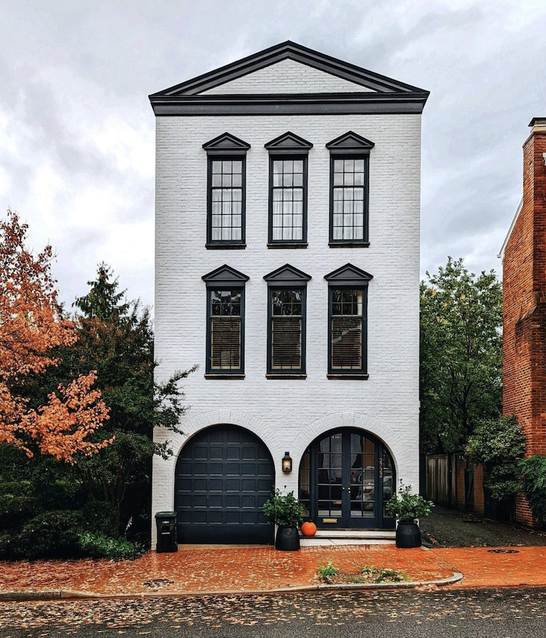 Black and white house with autumn leaves