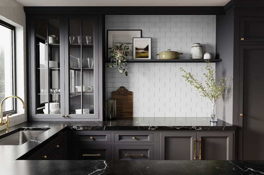 Kitchen with black cabinets, marble counters, and white backsplash